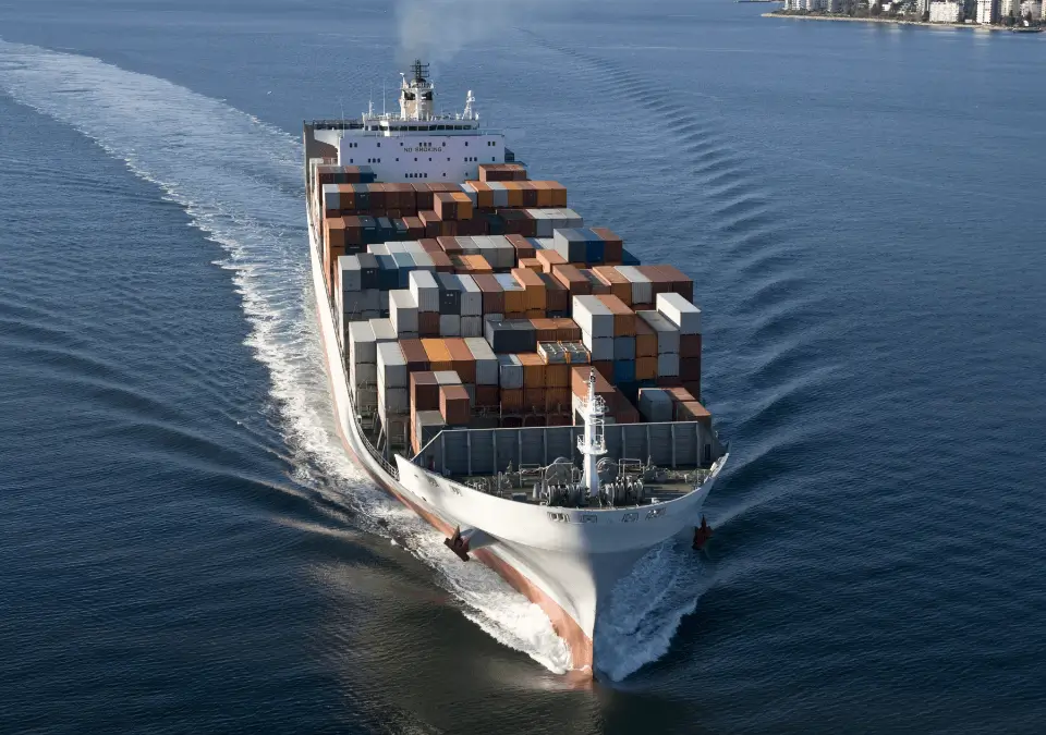 A large marine vessel carrying stacked containers.